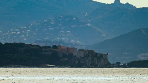 Distant view of multiple buildings on cliffs with many small white houses on Stock Footage 308713546
