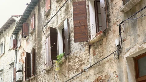 A distant view of the old and historic wall with windows and shutters. Stock Footage 136648284