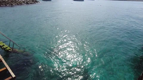 Distant view of people entering the sea and taking a boat ride on the sea. Stock Footage 239497825