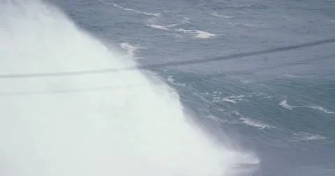 Distant view of professional surfer surfing through barrel wave in ocean Stock Footage 157715040