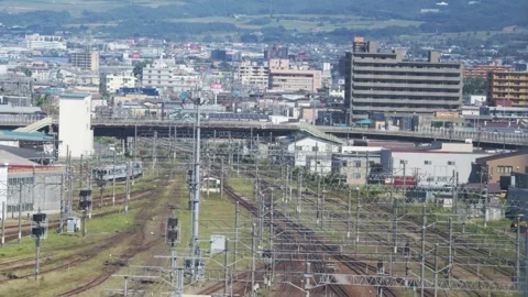 Distant view of rail yard and urban buildings, Hakodate, Japan, 2026.09.10. 動画素材 345424666