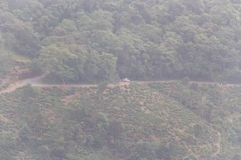 Distant View of a Small Vehicle Driving on a Winding Road Stock Photos