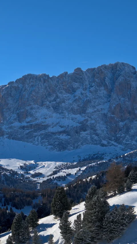 Distant view of snow on the trees and mountains in the Dolomites, Italy. Stock Footage 304401611