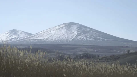 Distant view of a snowy mountain Stock Footage 166694145