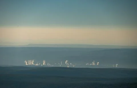 Distant View of Steam From Distant Thermal Pools Rise On The Landscape 写真素材