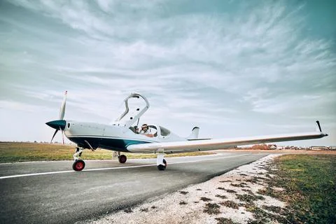 Distant view from a white small airplane with young pilot and co-pilot Stock Photos