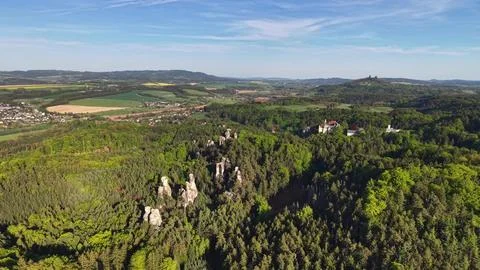 Distant Village Over Rolling Fields and Forested Ridge Aerial Panorama Show.. Stock Photos