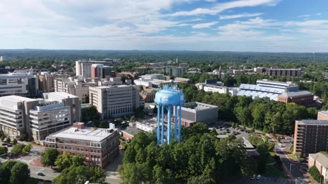 Distant Water Tower and Stadium Seats Over Campus Video stock 347701683