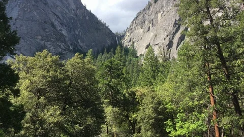 Distant waterfall above the forest and in the mountains Stock-Footage 90277712