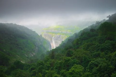 Distant waterfall in the mountains Stock Photos