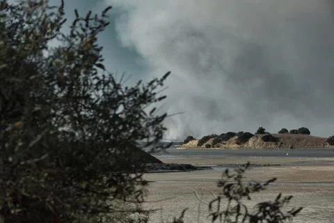 A distant wildfire sends a towering column of smoke in Albania Stock Photos