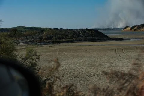 A distant wildfire sends a towering column of smoke in Albania Stock Photos