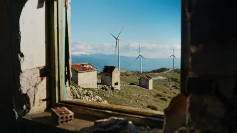 Distant Wind Turbines Viewed Through Abandoned Building Window Stock Footage 334580252
