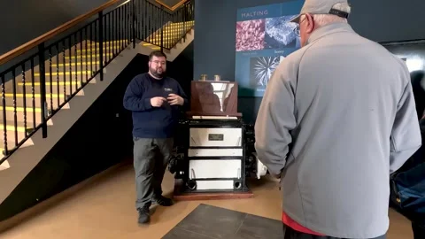 Distillery Guide Explains Malting Process to Tour Group Indoors Stock Footage 322580635