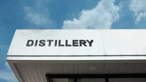Distillery word sign displayed on building with blue sky background Stock Footage 318626002