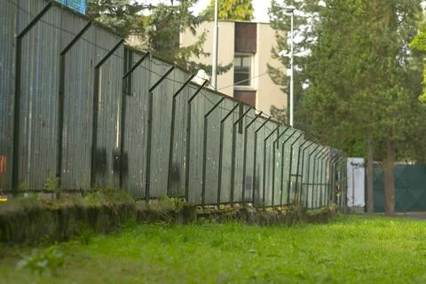 Distinct park boundary with industrial elements and textured foreground surface Fotos Stock