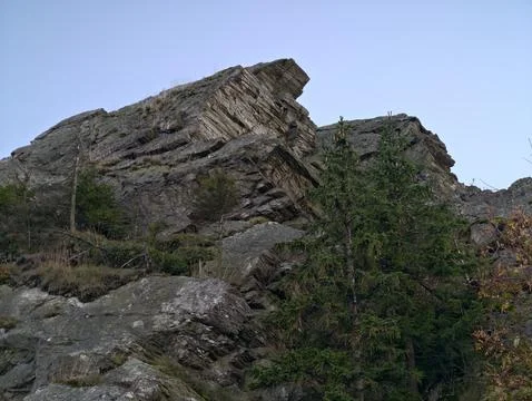 Distinct rocky ridge with pine, cliffside stratification featuring lone pine Stock Photos