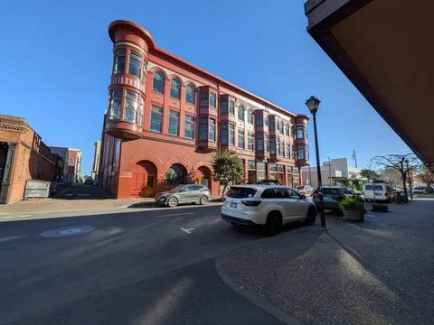 Distinctive brown building with rounded corners and projecting upper windows Stock Photos