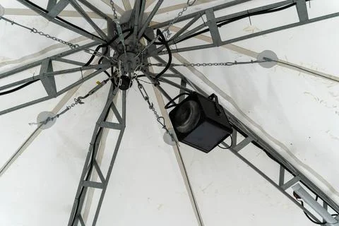 A distinctive lighting fixture hangs from a structural framework Foto stock