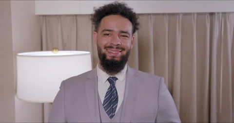 A Distinguished and Stylish Man Dressed in a Smart Suit Preparing for an Stock Footage 293295905