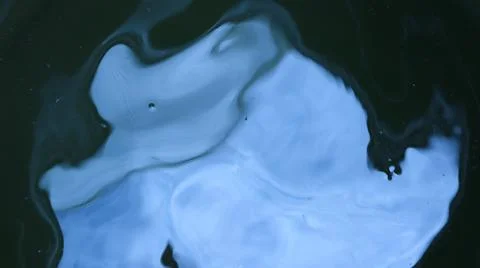 Distorted blue reflection on dark water surface Stock Photos