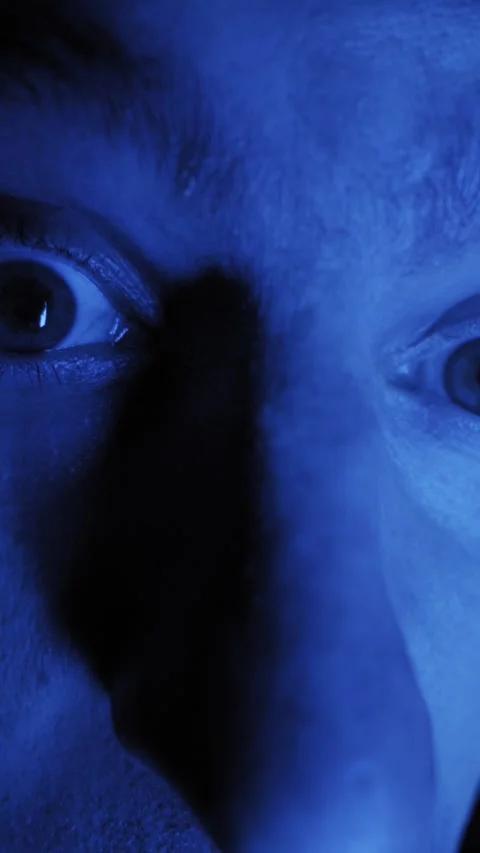 Distorted Male Face Staring Intensely Under Blue Light Video stock 329812925