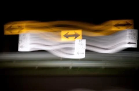 Distorted night view of traffic signs at aT intersection from drunk, drugged, Stock Photos