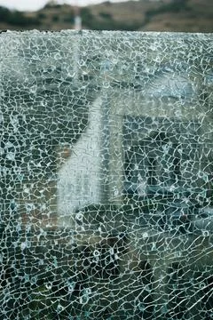 Distorted reflection of a building in a broken glass sheet, representing themes Fotos de archivo