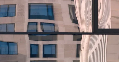 Distorted reflection in the glass of the window of a building standing opposite Stock Footage 119558034