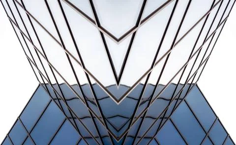 Distorted reflections in the mirrored windows of a modern building distort... Fotos de archivo