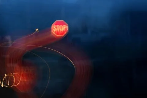 Distorted stop sign at road intersection as seen from drunk, drugged, or slee Stock Photos