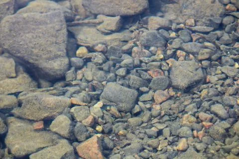Distorted view of slit covered rocks in water Stock Photos