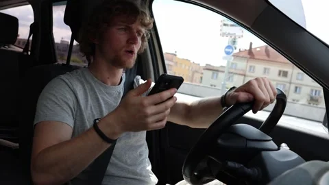 Distracted driver suddenly brakes while using smartphone on the road Stock Footage 343719783