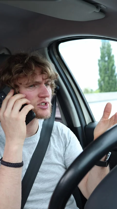 Distracted driver talks on a mobile phone while operating a moving car Stock Footage 342921393