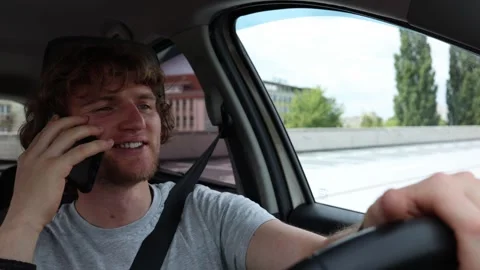 Distracted driver talks on phone while moving through urban traffic Stock-Footage 343720383
