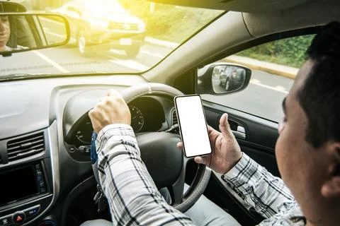 Distracted driver using the cell phone while driving, Man using his phone w.. Stock Photos