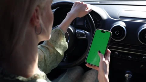 Distracted Driving: A Risky Trend of Using Smartphones with Green Screens While Stockbeeldmateriaal 314460218