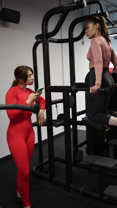 Distracted trainer ignores client workout Stock Footage 337956840