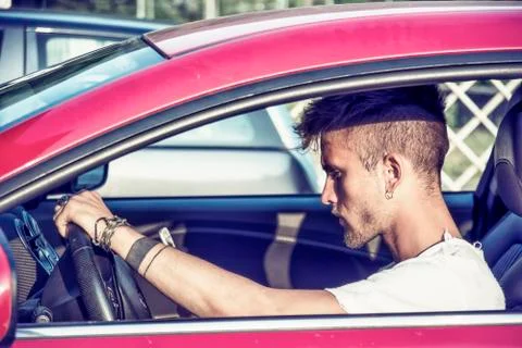 Distracted Young Man Using Cell Phone While Stock Photos