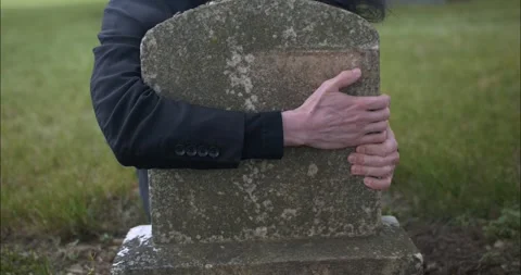 Distraught, crying man hugging grave tom... | Stock Video | Pond5