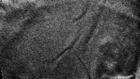 Distressed black denim texture showcasing gritty raw weave and high contras.. Stock Photos