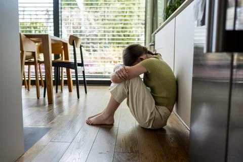 Distressed child facing aggressive parenting and emotional fear at home. Stock Photos