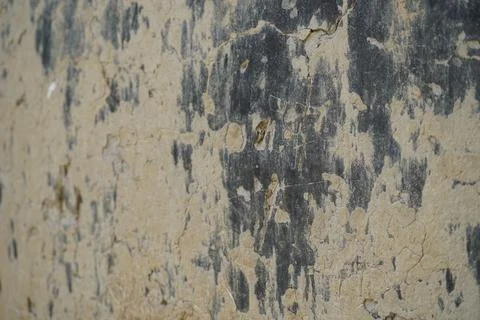 Distressed concrete wall texture with peeling grey paint and weathered industria Stock Photos