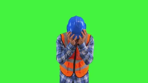 Distressed construction worker covering face with hands, wearing orange ves.. Stock Footage 286985701