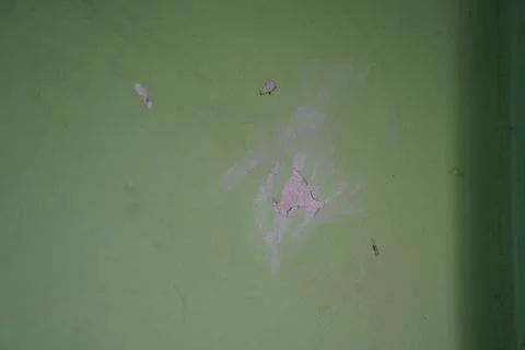 Distressed green wall texture with peeling paint and surface damage for backg Stock Photos