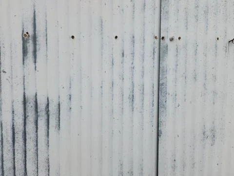 Distressed metal siding texture with rust streaks and vertical ridges Stock Photos