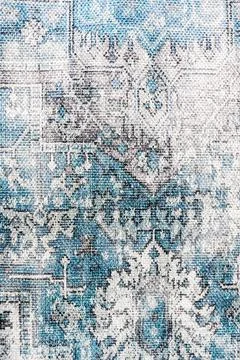 Distressed rug fabric with an abstract pattern and faded blue, gray, and wh.. Foto stock