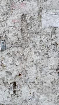 Distressed Wall Texture with Torn Paper Posters and Rust Spots Stock Photos