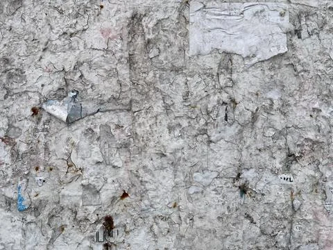 Distressed Wall Texture with Torn Paper Posters and Rust Spots Stock Photos