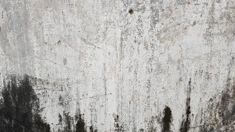 Distressed white concrete wall texture with dark grunge stains and weathered 스톡 사진
